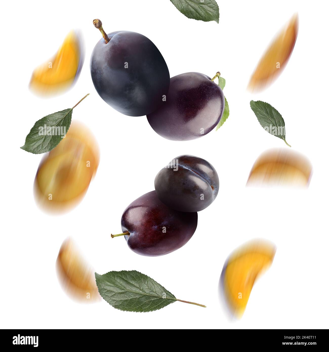 Many falling plums on white background Stock Photo Alamy