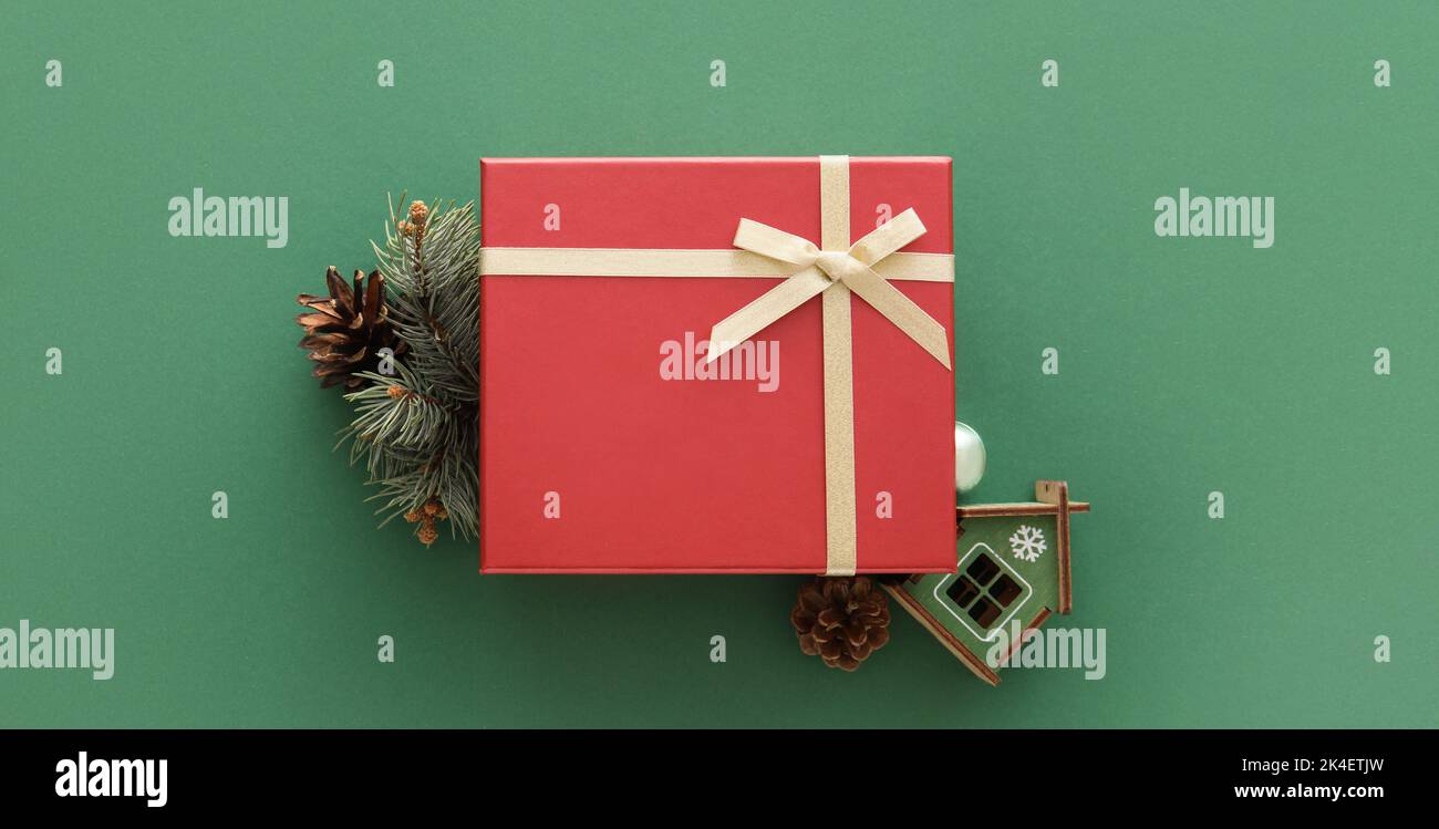 Christmas gift box and fir branch on green background Stock Photo - Alamy