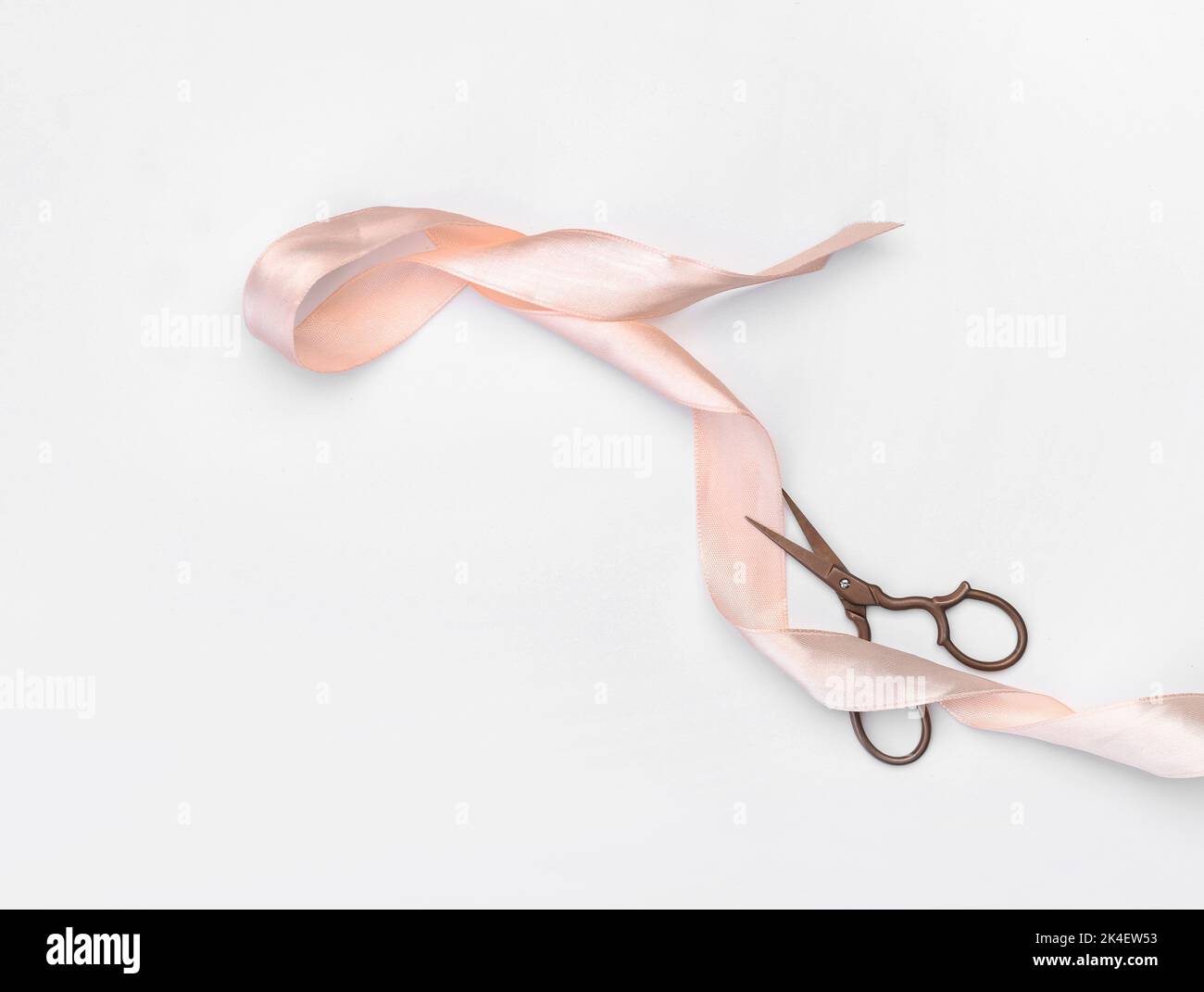 Scissors and ribbon on white background Stock Photo - Alamy