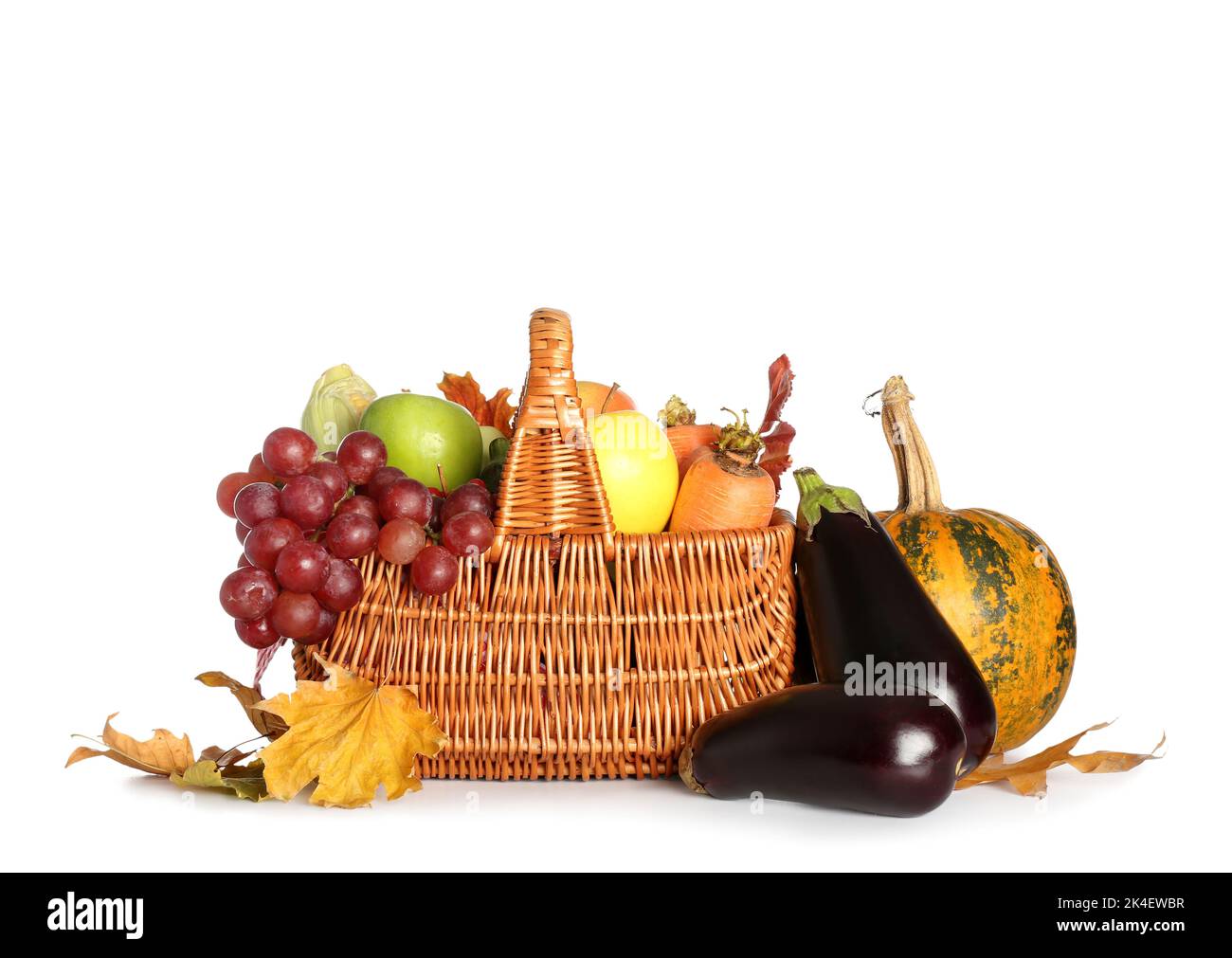 Wicker basket with fresh fruits and vegetables on white background ...