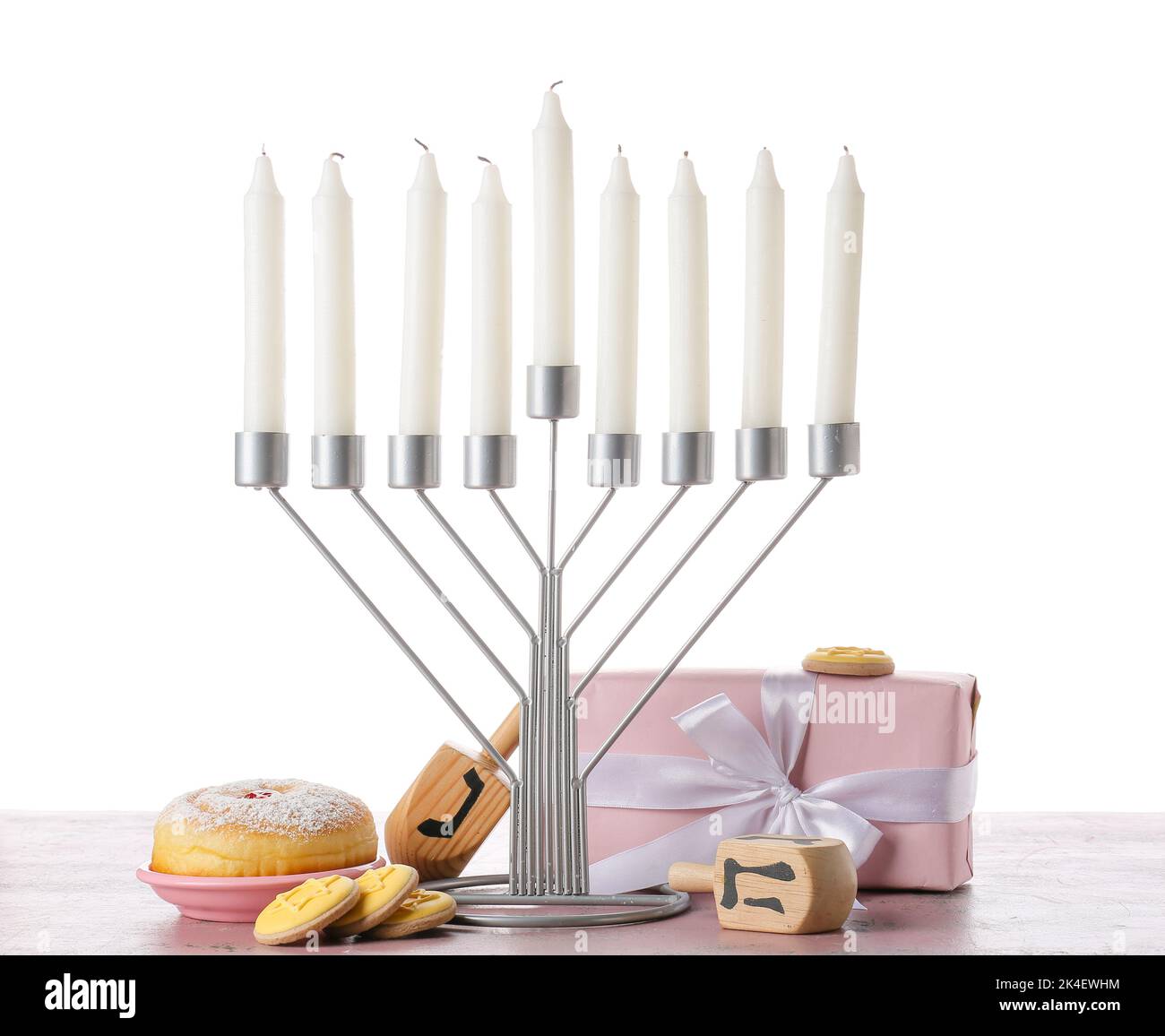 Menorah with candles, dreidels, delicious food and gift box for