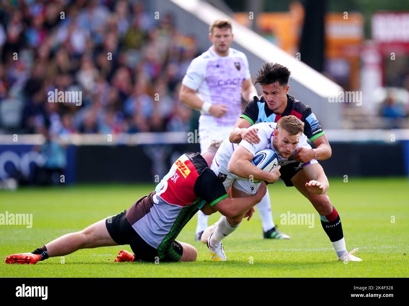Northampton Saints' Rory Hutchinson is tackled by Harlequins' Marcus Smith and Jack Musk during the Gallagher Premiership match at the Twickenham Stoop, London. Picture date: Sunday October 2, 2022. Stock Photo