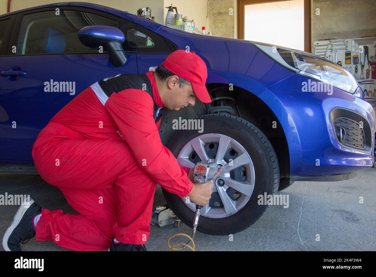 Tire dealer who disassembles the wheels of a tire changing machine with