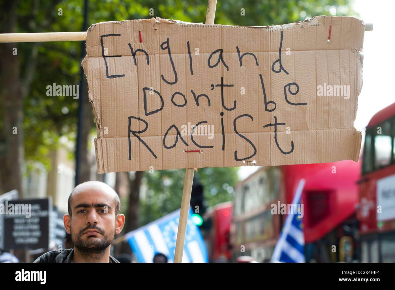 London. Whitehall. A lone protester carries a hand made sign saying 'England dont be racist'. Stock Photo