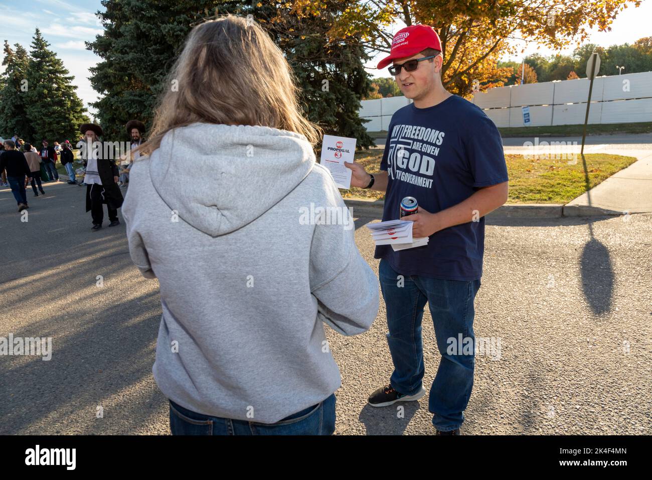 Warren, Michigan, USA. 1st Oct, 2022. Joshua Hillwig, talks with people arriving at a Donald Trump rally. He is urging them to vote against Proposal 3 in Michigan's November election. Proposal 3 would add the right to abortion to Michigan's constitution. Credit: Jim West/Alamy Live News Stock Photo