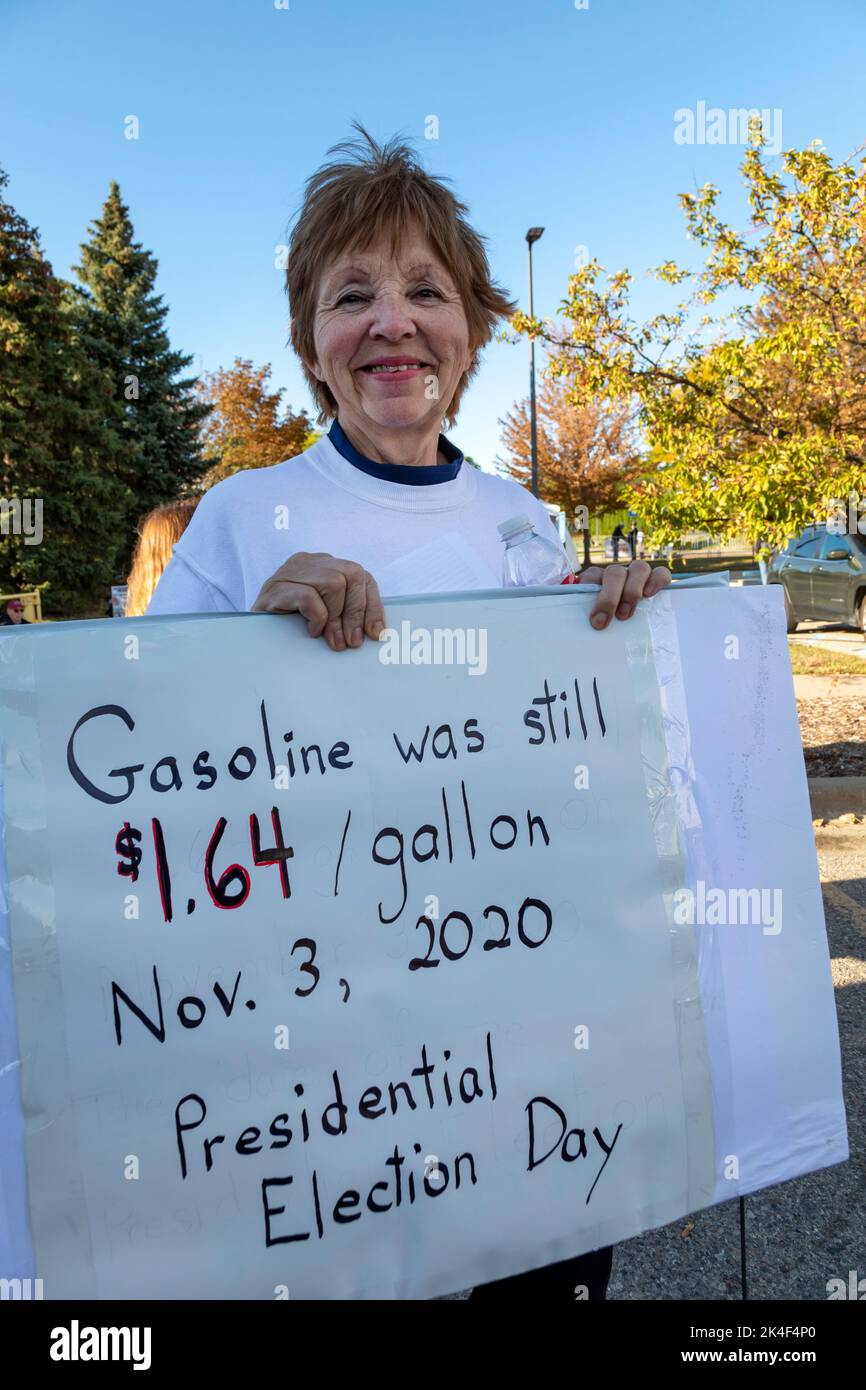 Warren, Michigan, USA. 1st Oct, 2022. Donald Trump supporters outside a rally where the former president campaigned for the candidates he has endorsed in the 2022 Michigan general election. A supporter who would give her name only as 'Jean' carries a sign about gasoline prices. Credit: Jim West/Alamy Live News Stock Photo