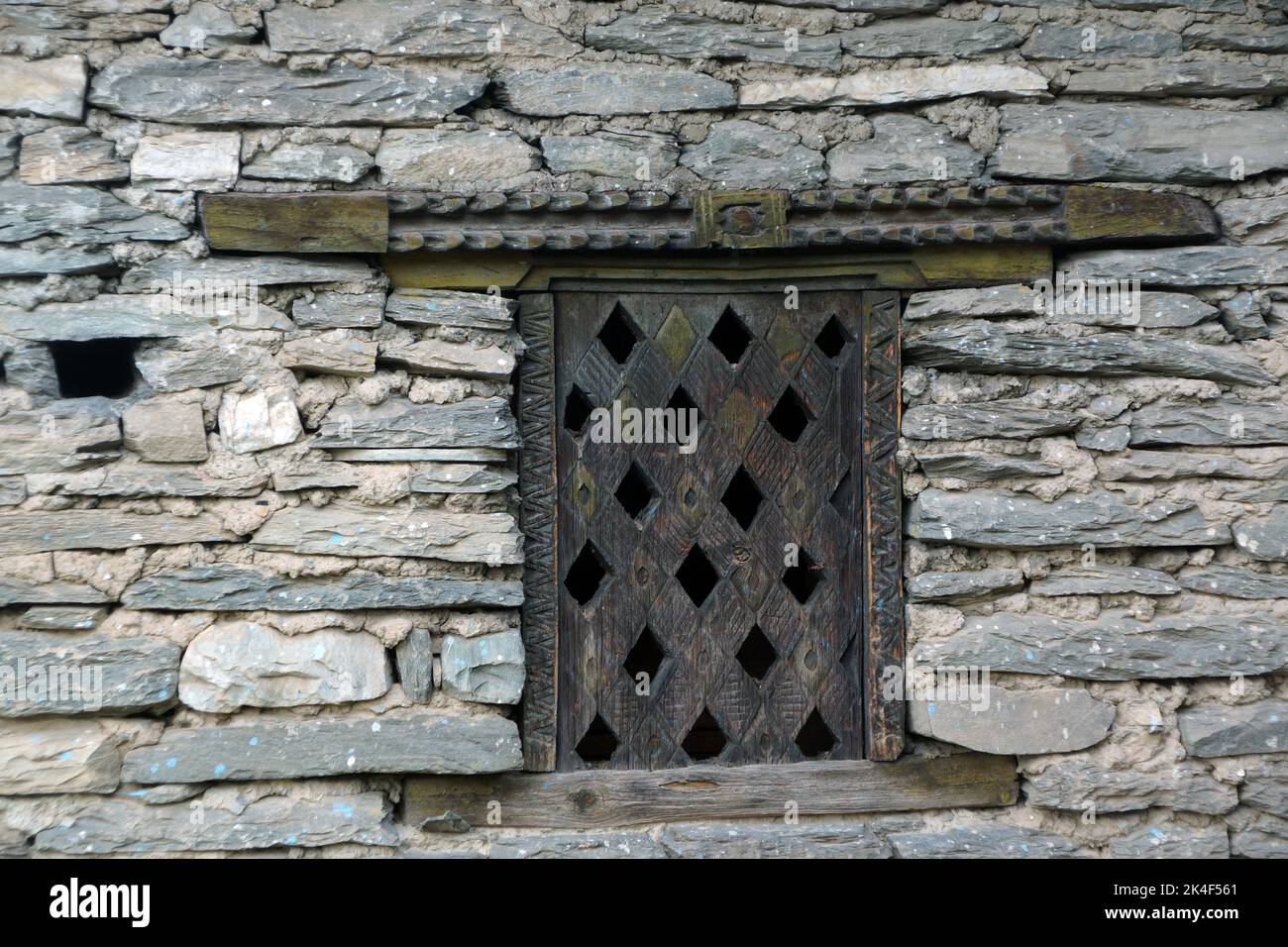 Wooden windows in a traditional stone house in Nepal Stock Photo