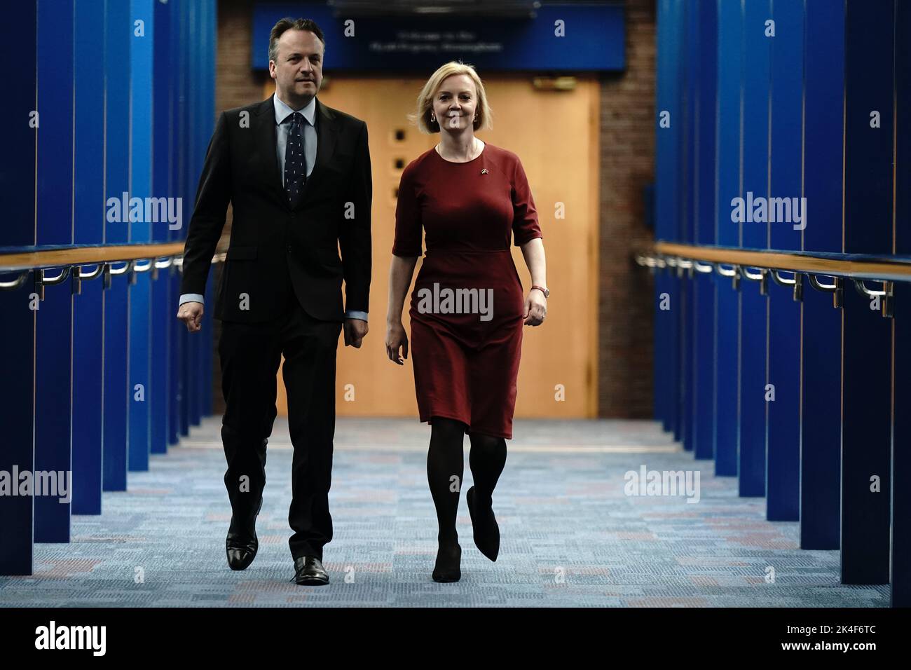 Prime Minister Liz Truss and her husband husband Hugh O'Leary, walk across the Hyatt hotel bridge at the Conservative Party annual conference at the International Convention Centre in Birmingham. Picture date: Sunday October 2, 2022. Stock Photo