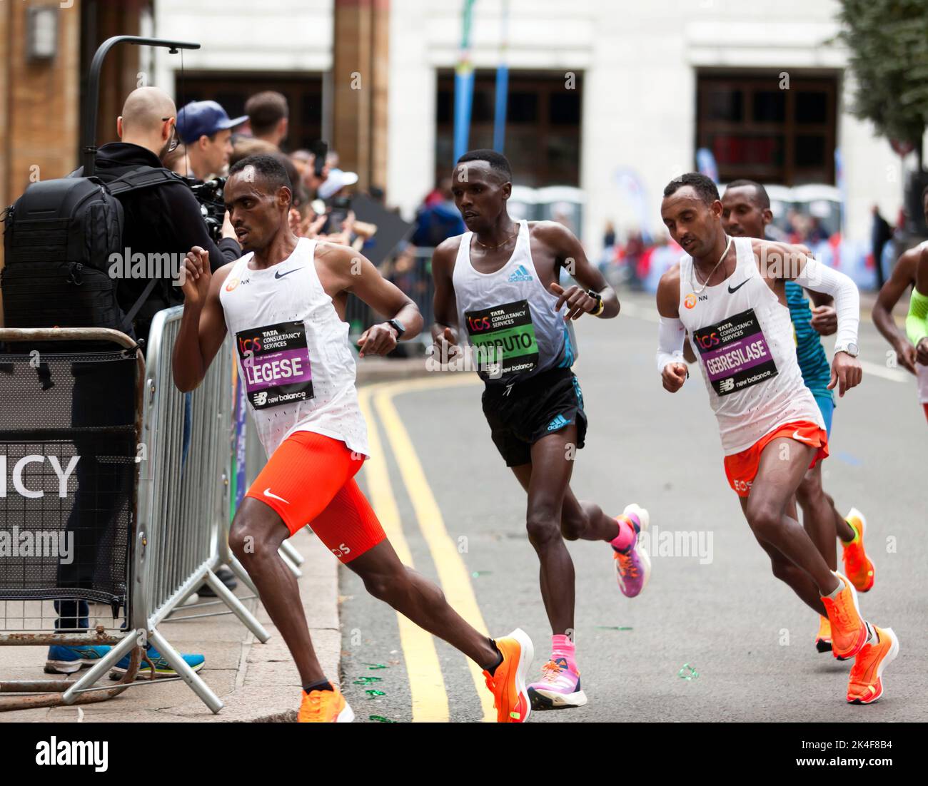 Elite runners, Birhanu Legese, Amos Kipruto and Leul Gebresilase pass through Cabot Square, during the 2022 London marathon. Amos Kipruto  went on to win in a time of 2:04:39; Credit John Gaffen/Alamy Live News Stock Photo