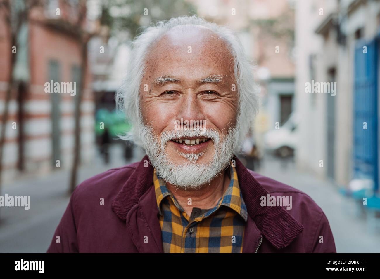 Portrait of happy Asian senior man smiling in front of camera Stock Photo