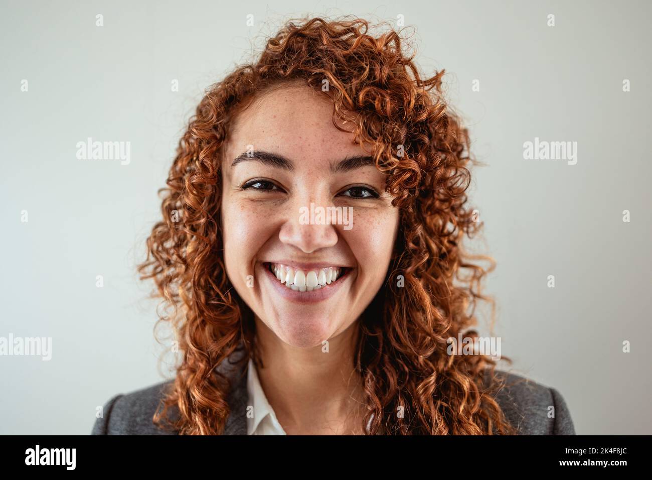Business woman having fun looking in front of camera inside office Stock Photo