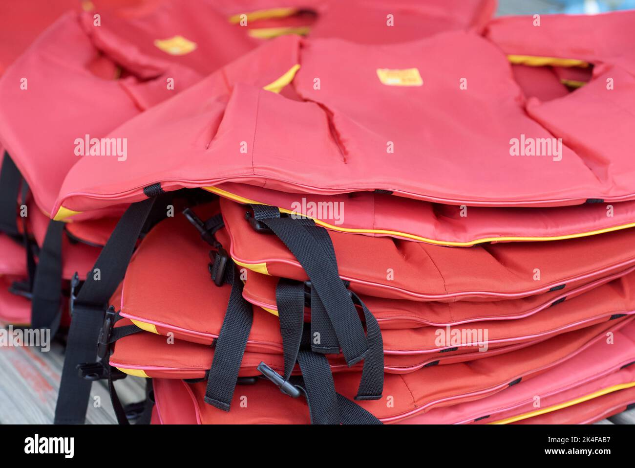 A stack of red life jackets Stock Photo