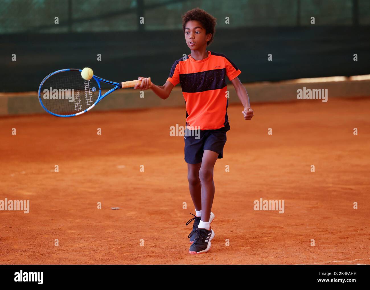Young coloured boy playing tennis in Opatja, Croatia,Europe Stock Photo