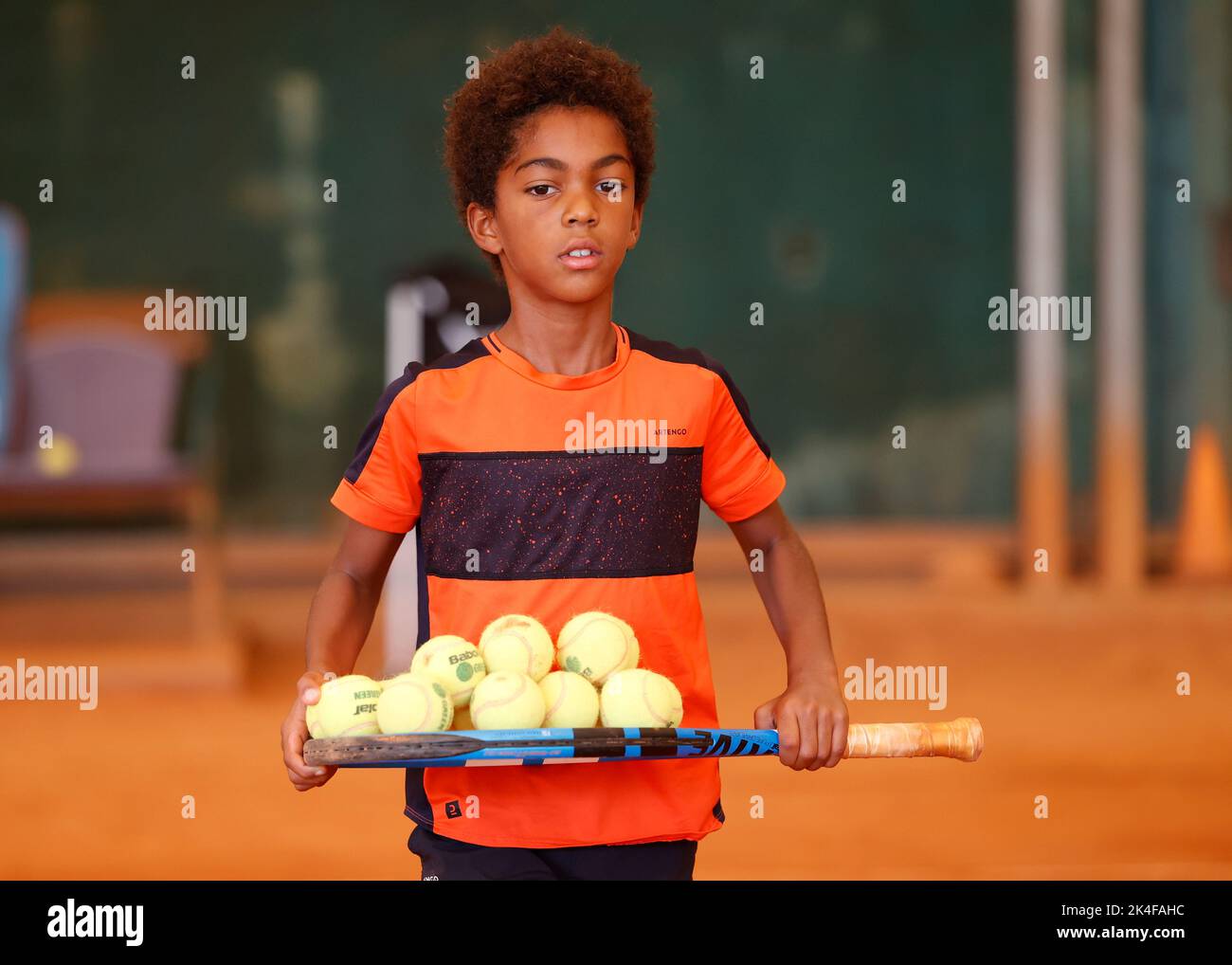 Young coloured boy playing tennis in Opatja, Croatia,Europe Stock Photo