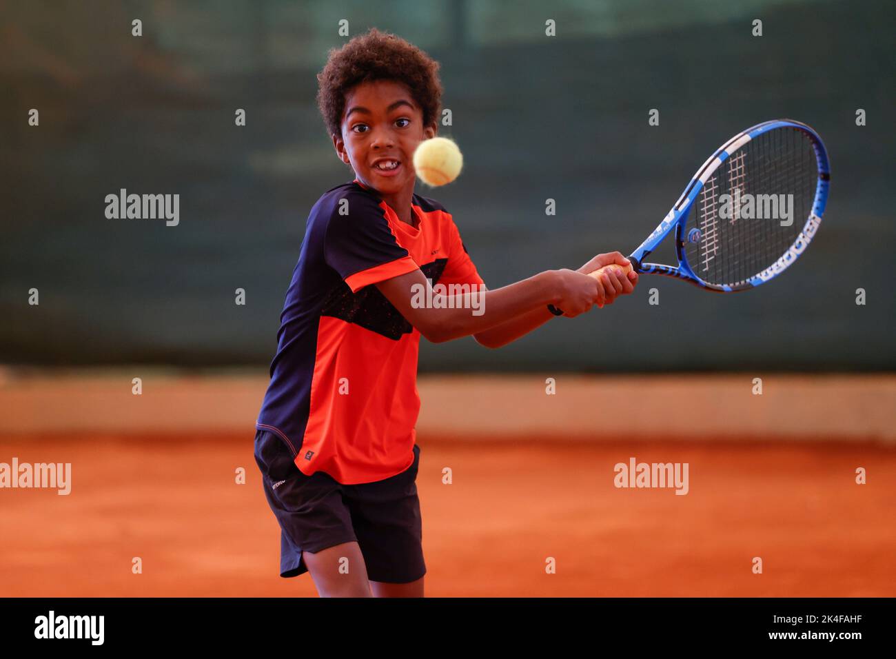 Young coloured boy playing tennis in Opatja, Croatia,Europe Stock Photo