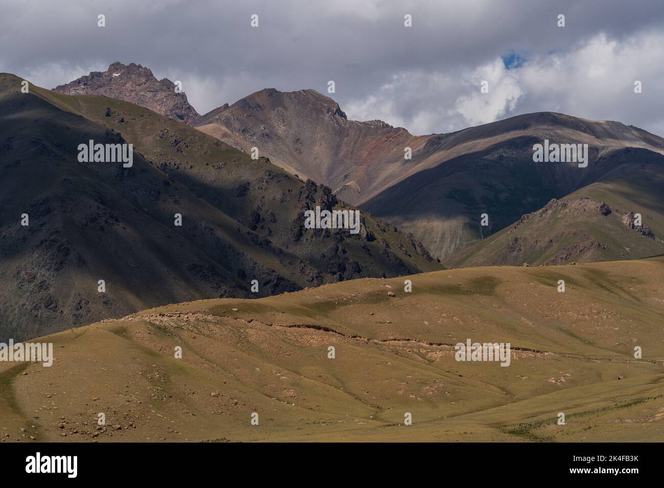 Landscape and road on the way to Song Kul Lake, Kyrgyzstan Stock Photo