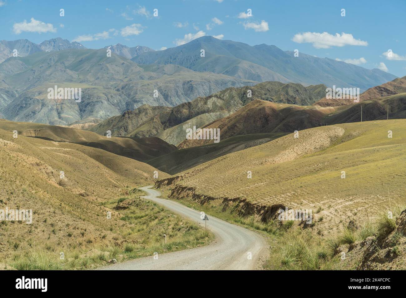 Landscape and road on the way to Song Kul Lake, Kyrgyzstan Stock Photo
