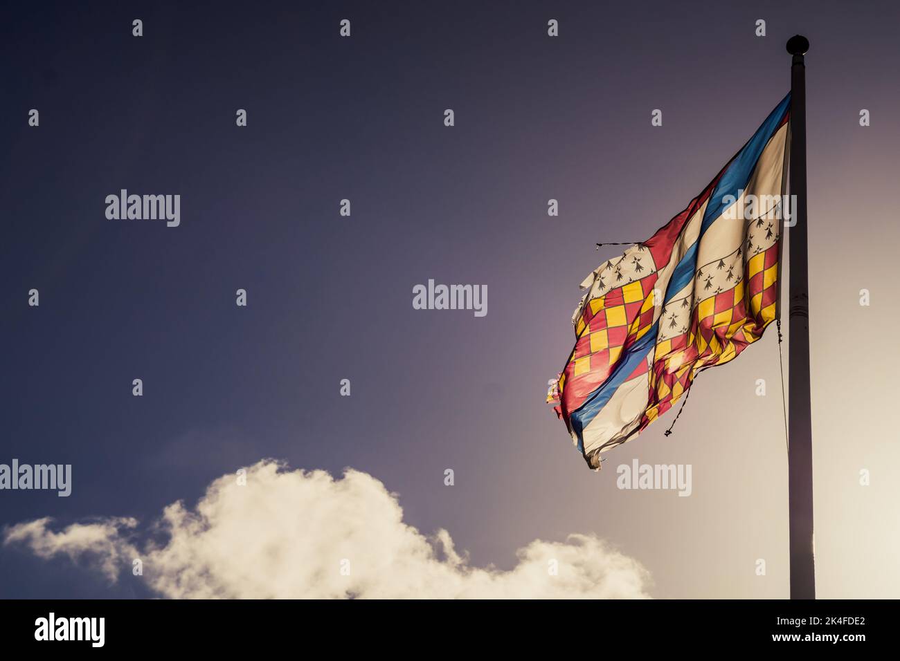 Colourful Flag against a blue sky Stock Photo
