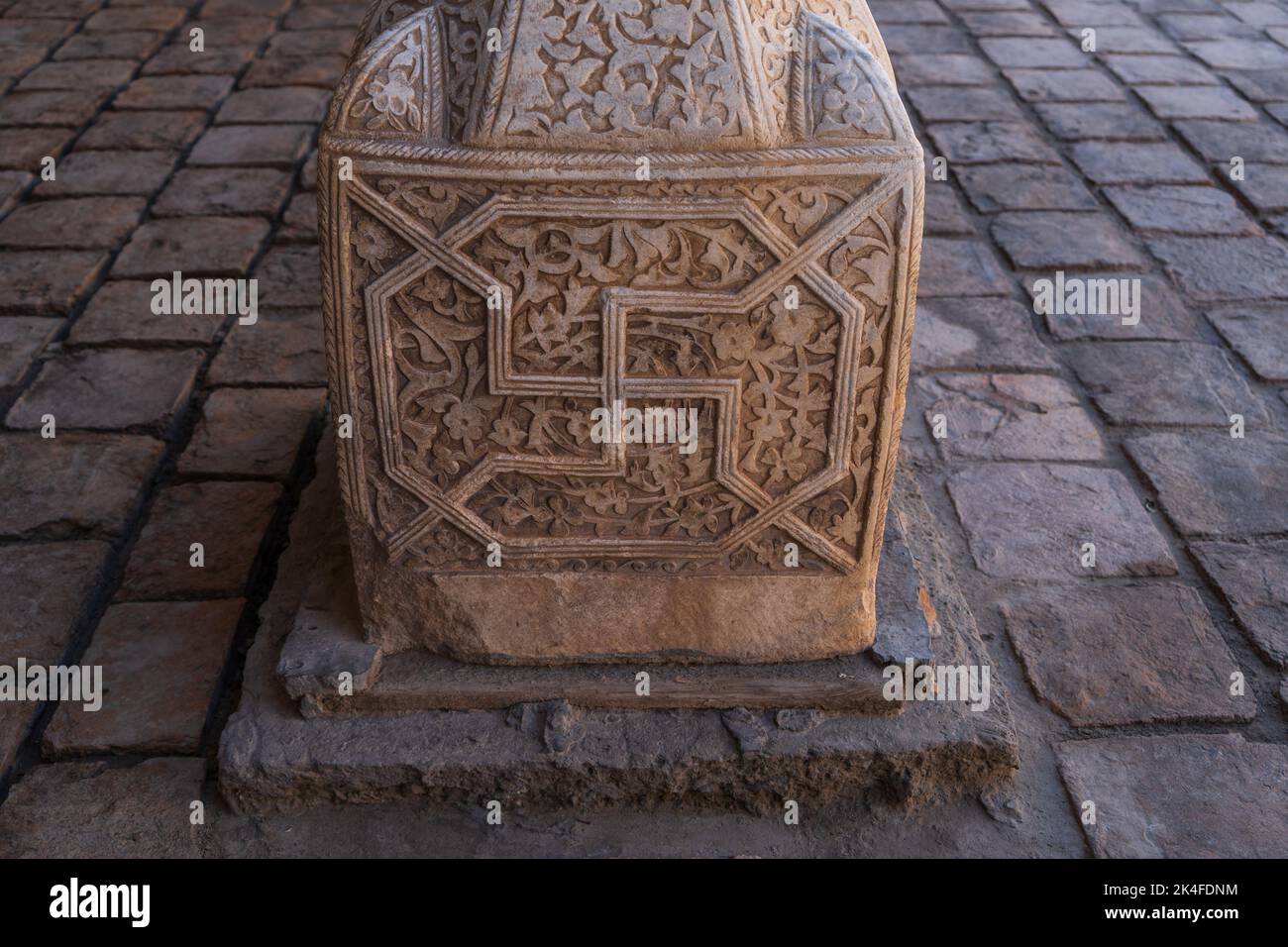Carved column with traditional swastika symbol in Tash Khauli Khorezm in Khiva Stock Photo