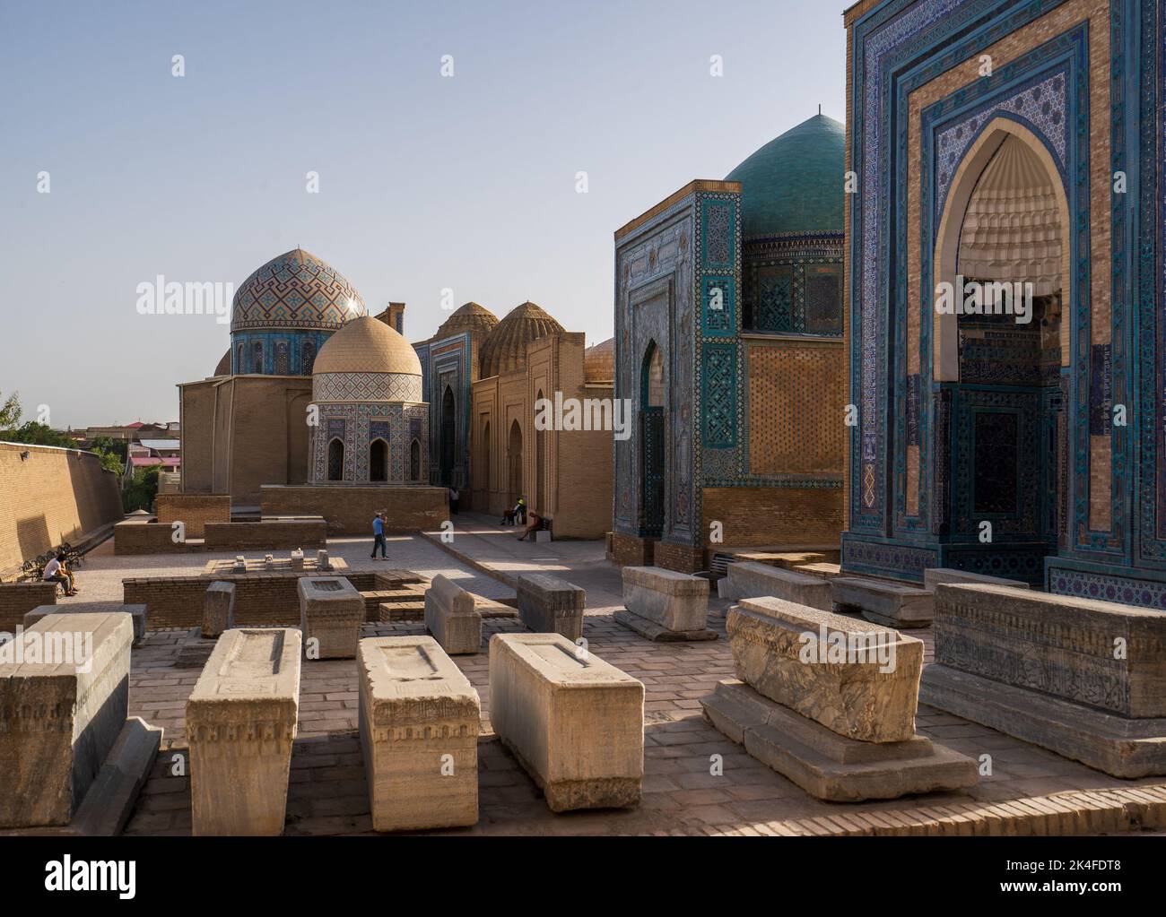 Blue tiled facades and arches of the Shah-i-Zinda mausoleum complex at sunset, Samarkand Stock Photo