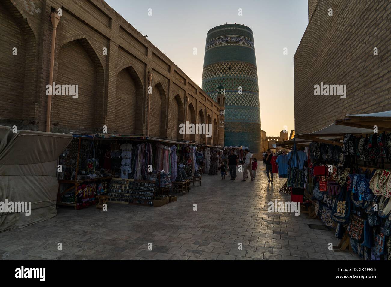 Kalta Minor minaret and surrounding narrow streets with market stalls of old town in Itchan Kala, Khiva Stock Photo