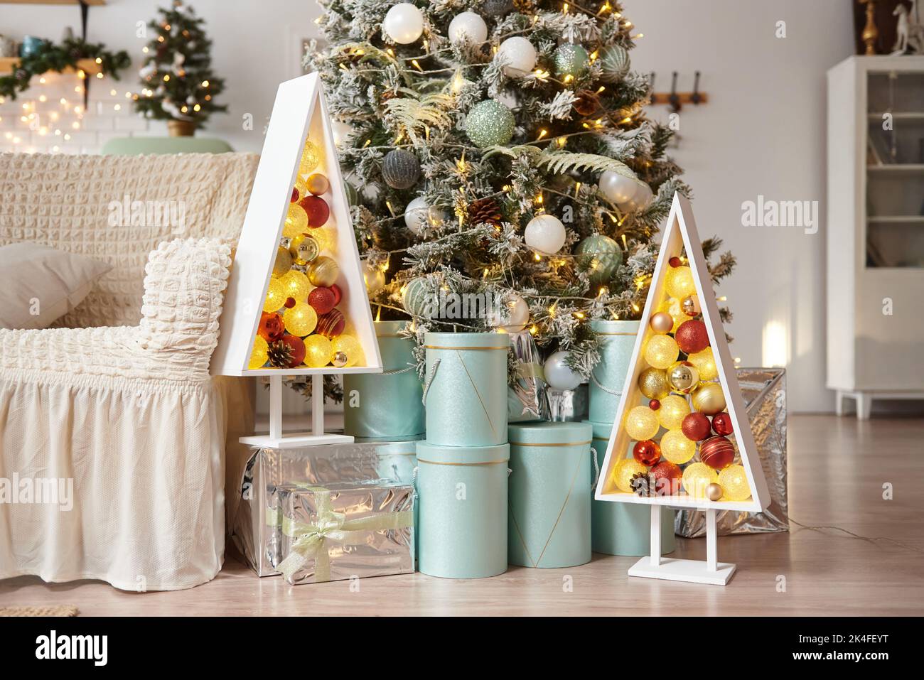 Christmas cozy living room interior with wooden Christmas tree. Stock Photo