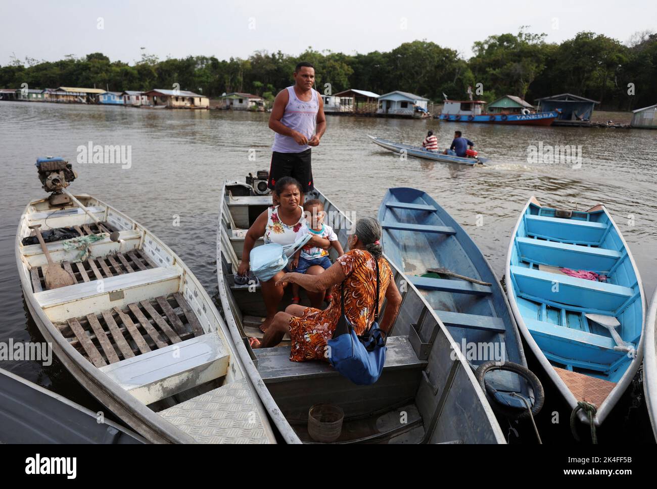 People arrive to cast their votes at a polling station set up on a floating school on the Negro river, in the Catalao Community, Brazil October 2, 2022. REUTERS/Bruno Kelly Stock Photo