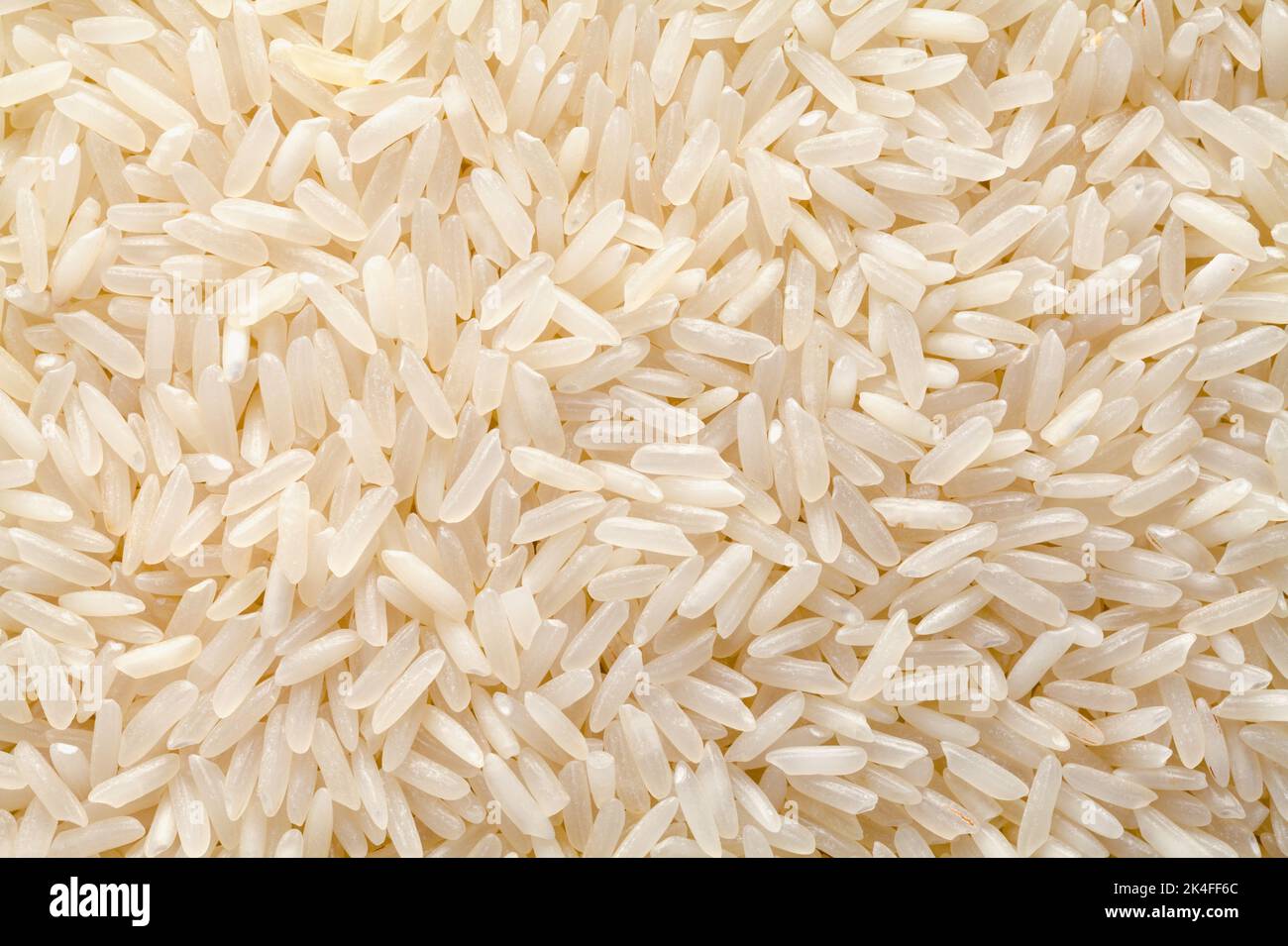 Dry Long Grain White Rice Pile Background. Stock Photo