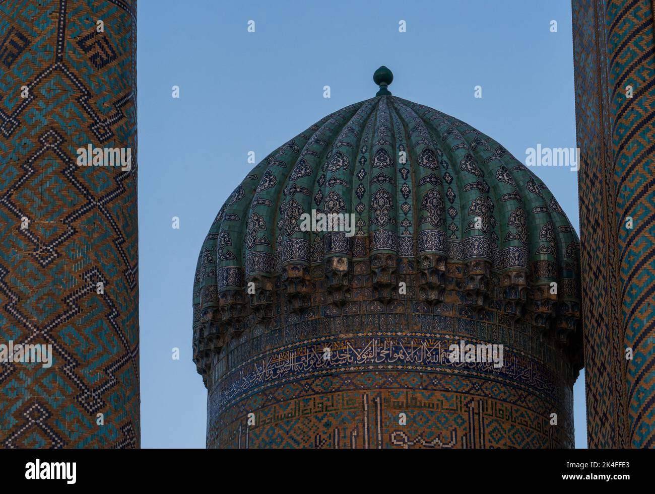 Registan intricate blue tile dome and minaret at sunset, Samarkand Stock Photo