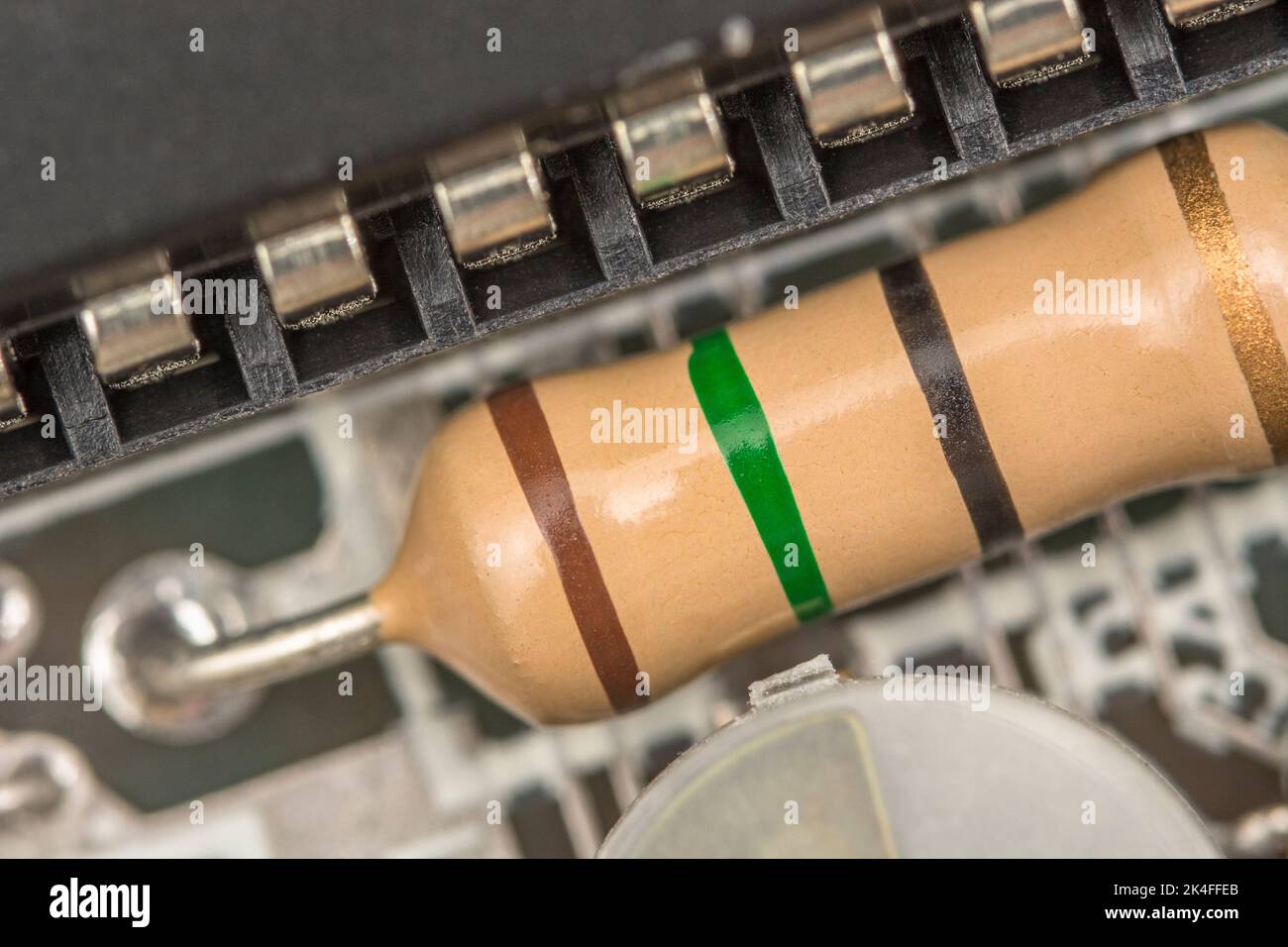 Thought to be a large size carbon resistor seen on Sinclair ZX Spectrum motherboard. Is about 10-15mm long & much larger than other nearby resistors. Stock Photo