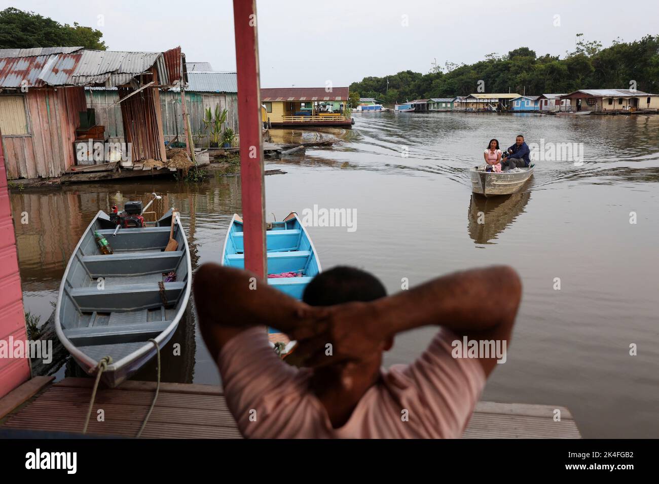 People arrive to cast their votes at a polling station set up on a floating school on the Negro river, in the Catalao Community, Brazil October 2, 2022. REUTERS/Bruno Kelly Stock Photo