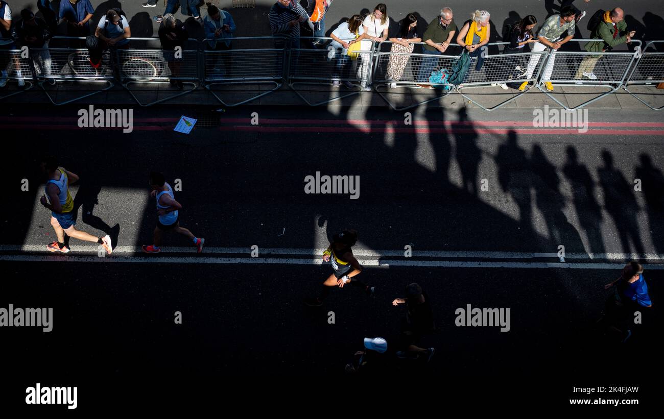 London, UK. 2 October 2022. Spectators watch runners taking part in the