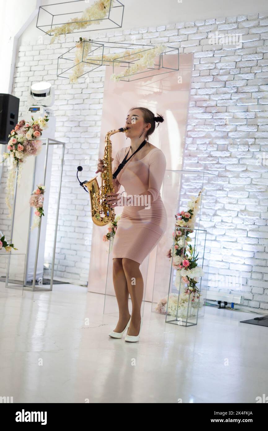 Beautiful girl playing saxophone Stock Photo
