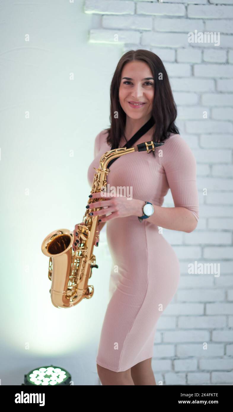 Beautiful girl playing saxophone Stock Photo