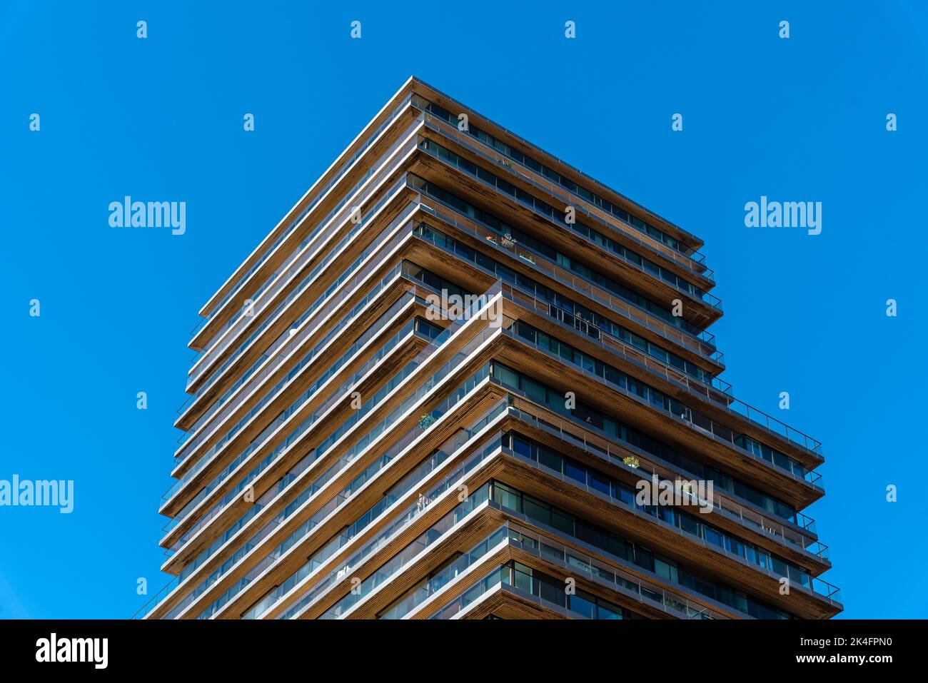 Rotterdam, Netherlands - May 8, 2022: New apartment building in the waterfront of Meuse River. Low angle view against sky Stock Photo