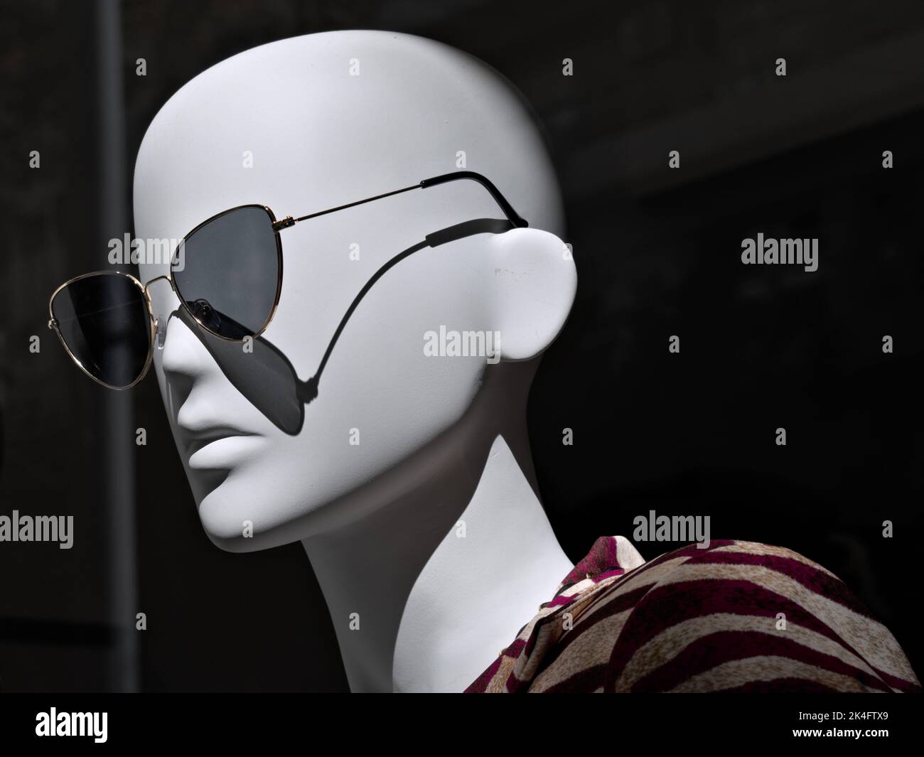a mannequin wearing sunglasses in a display window Stock Photo Alamy