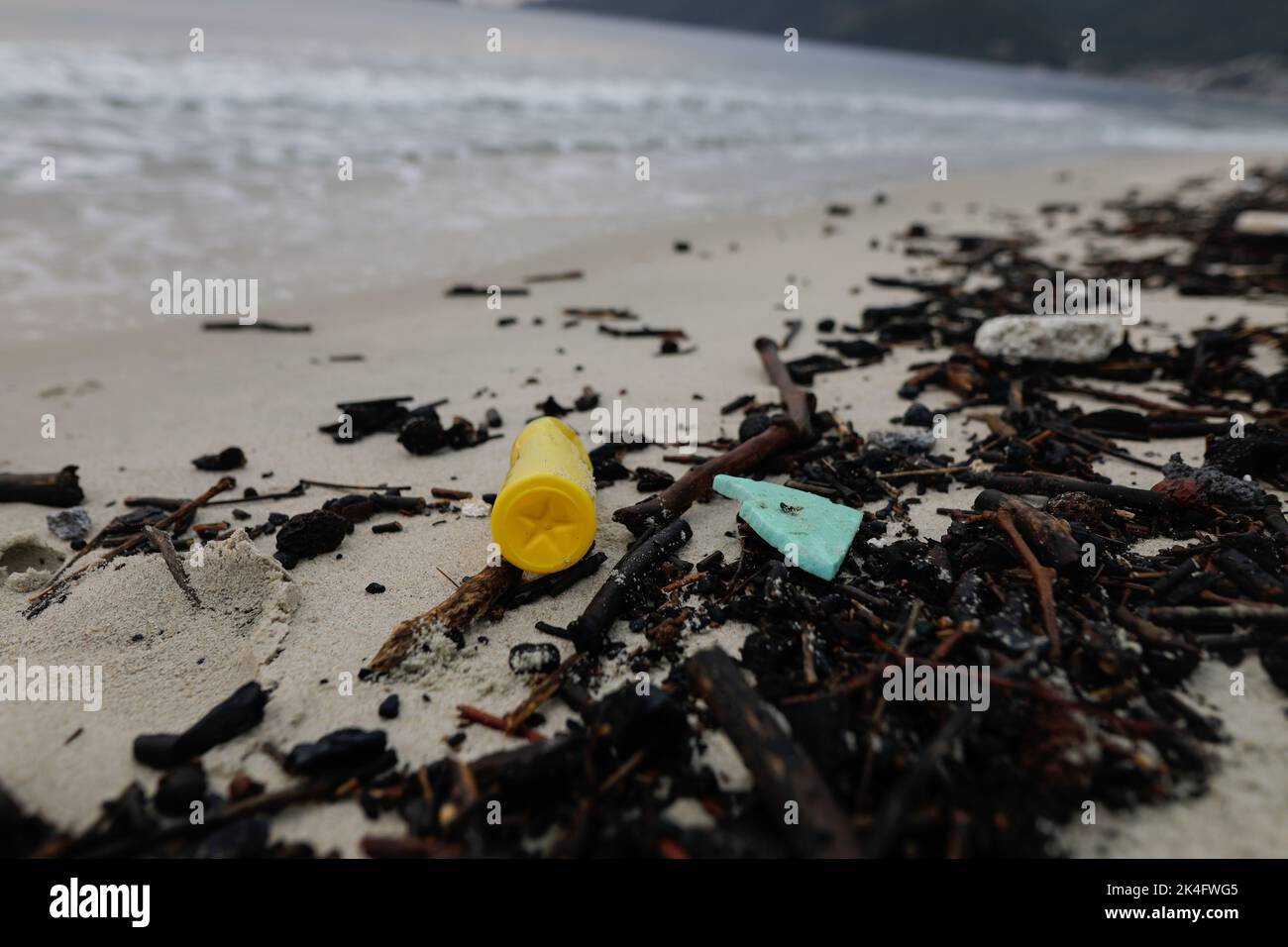 Plastic and wood waste washed ashore on the Golden Beach in Thassos after a powerful storm on a cloudy summer morning. Stock Photo