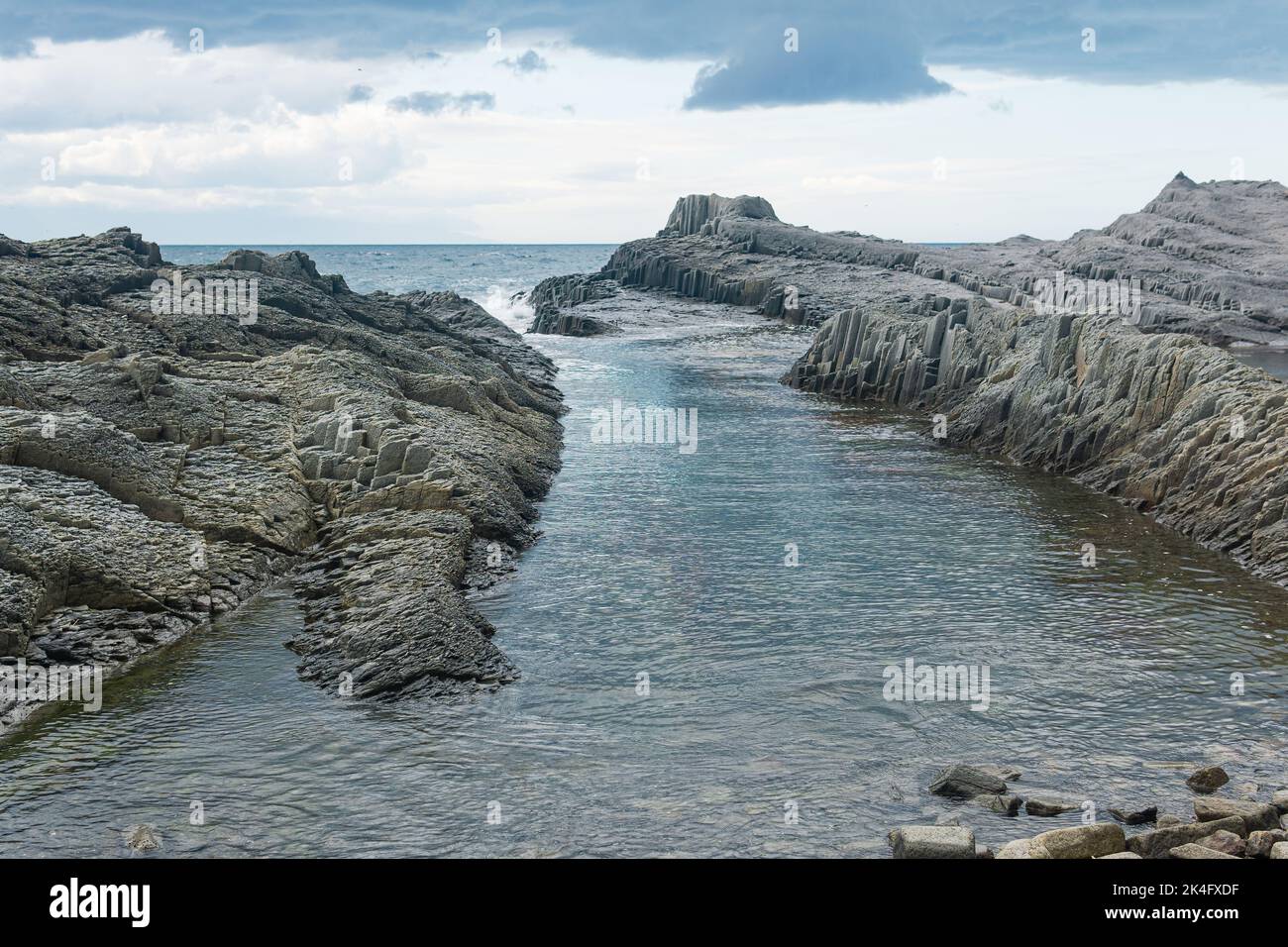 coastal seascape with beautiful columnar basalt rocks at low tide Stock Photo