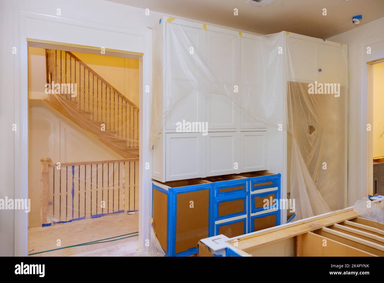 Assembling white kitchen furniture interior with a newly