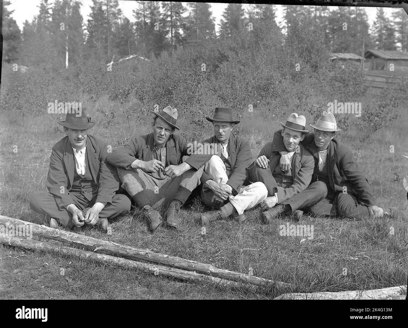 Portrait of a sitting group of men in an outdoor environment. Lima, Dalarna Nordic Stock Photo