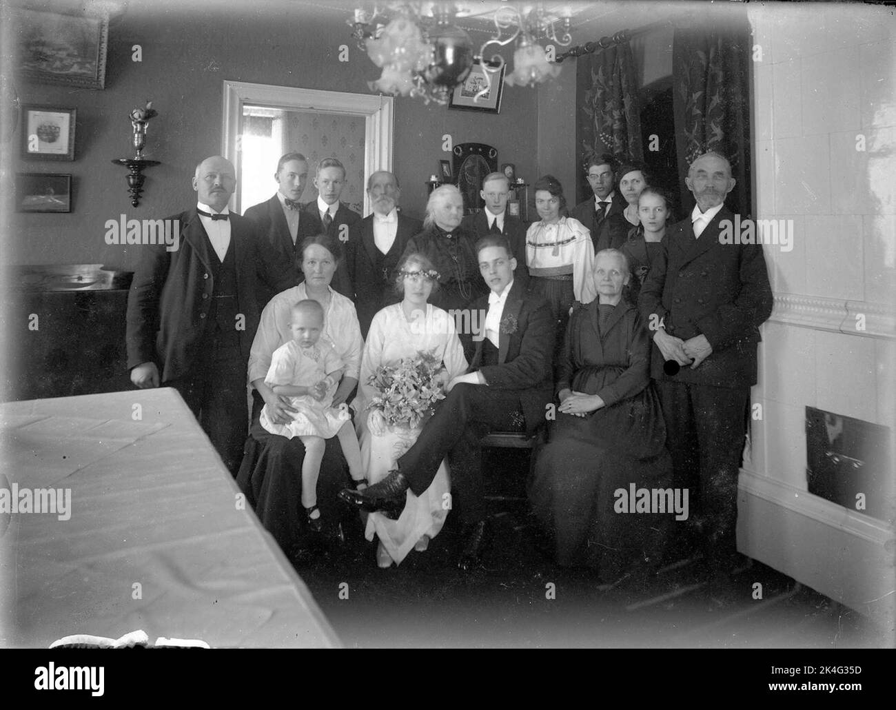 Group picture of wedding companion with the bridal couple in the middle. Interior. Lima, Dalarna Nordic Stock Photo