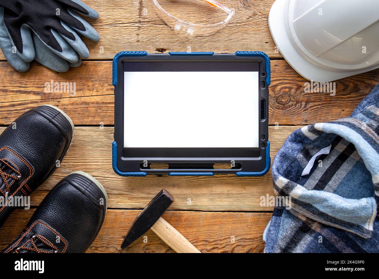 Builder uniform and digital tablet on wooden background, flat lay Stock ...