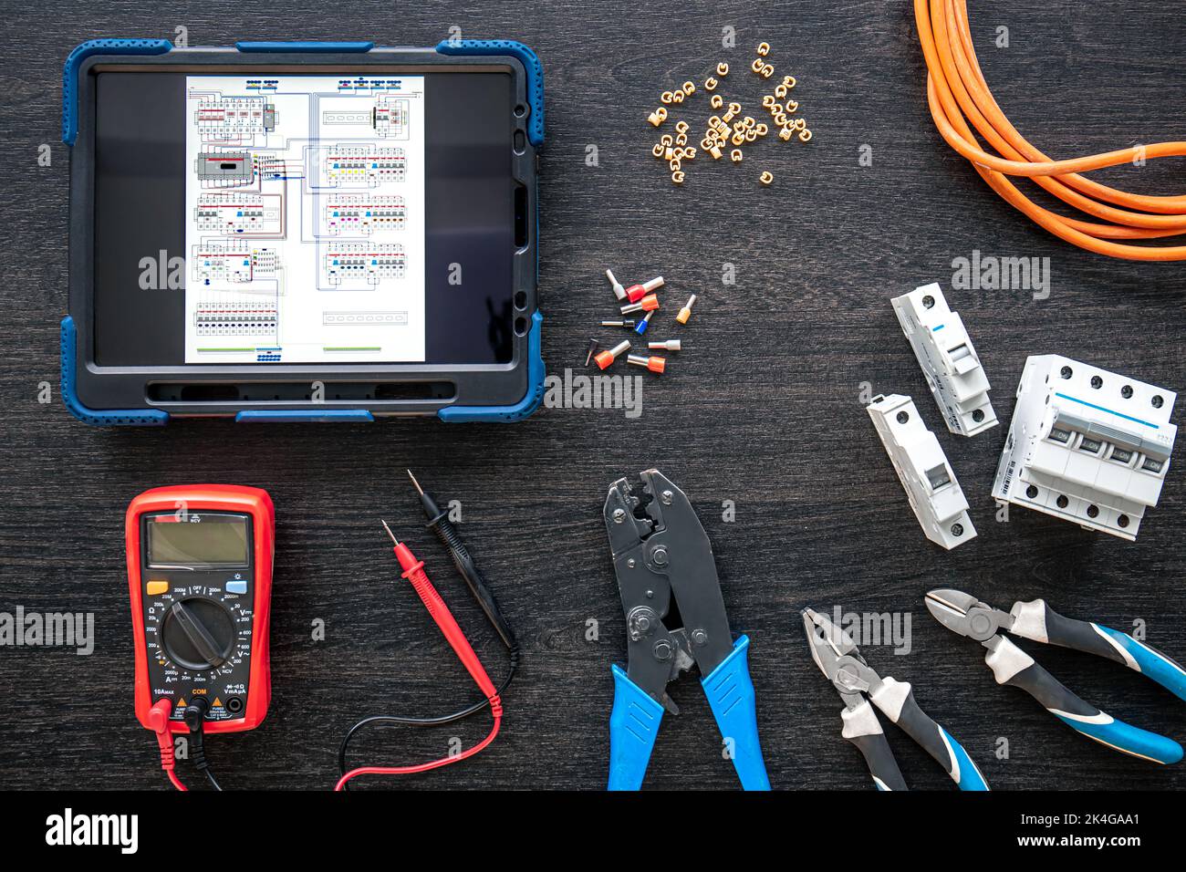 Different electrical tools and digital tablet on wooden background, flat lay. Stock Photo