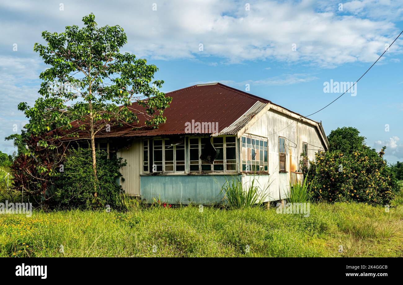An old abandoned house with trees under a blue sky with clouds Stock ...