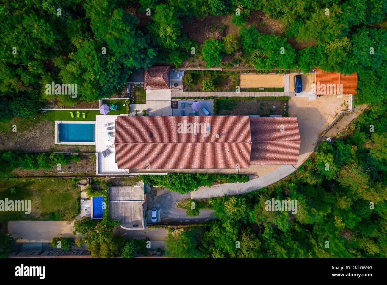 An aerial view of a big villa with a swimming pool, private garden, and ...