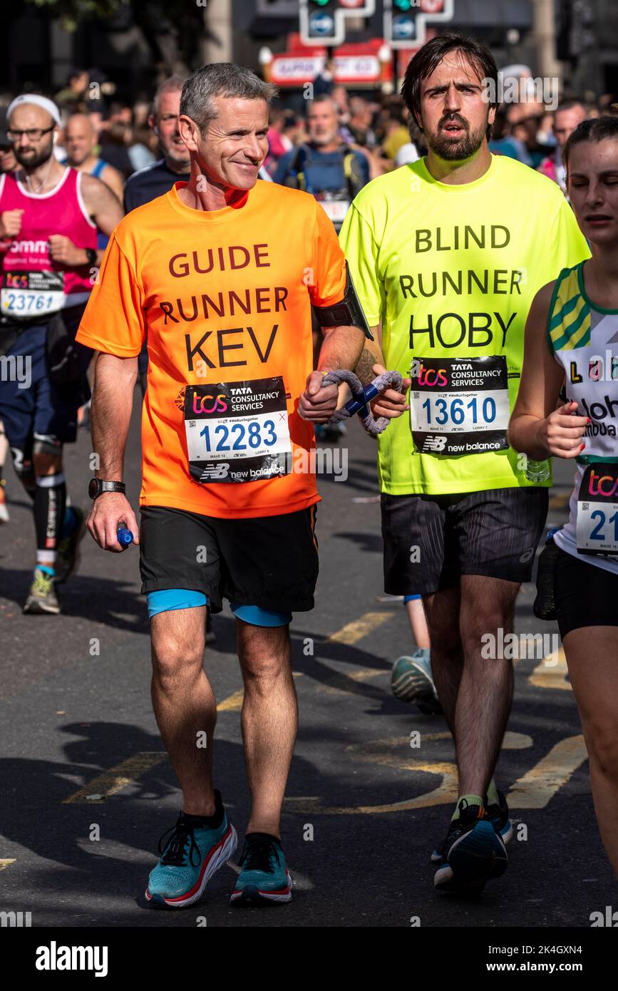 Blind runner with guide runner, running in the TCS London Marathon 2022