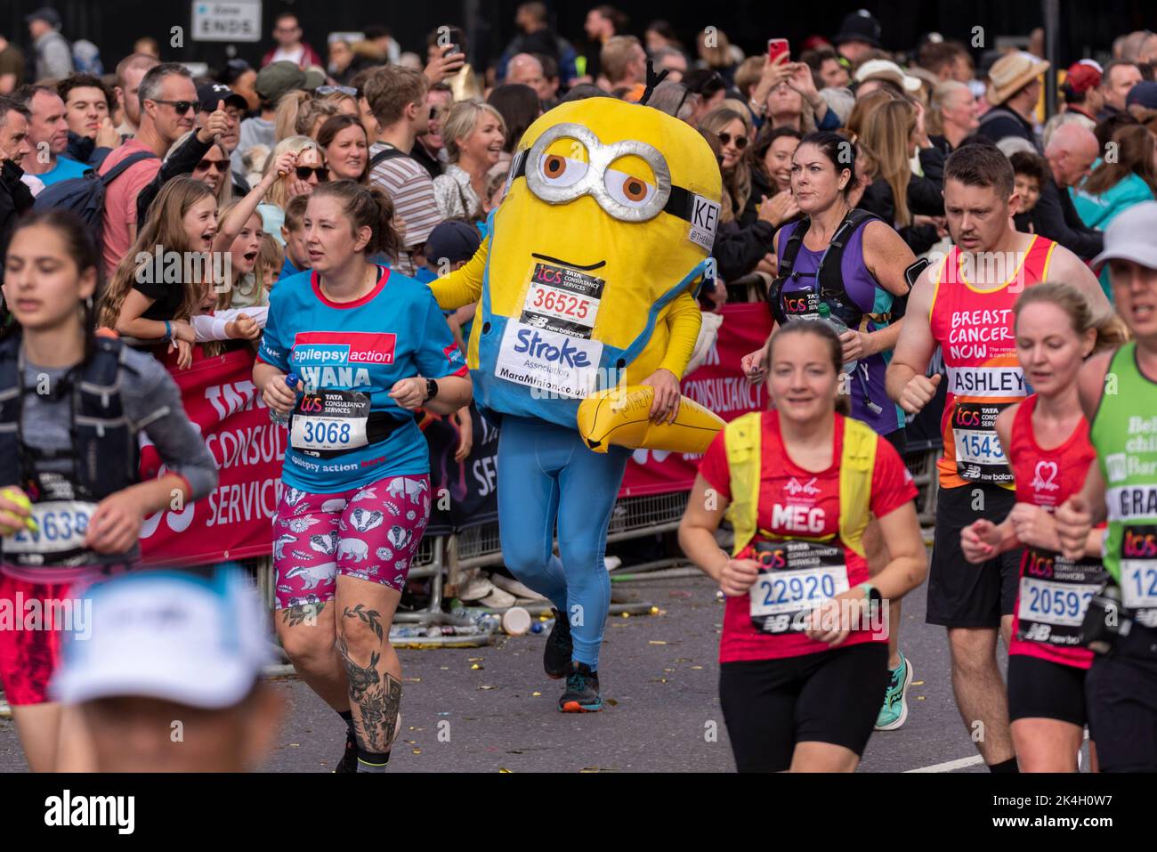 Kevin Isbister running in the TCS London Marathon 2022, on Tower Hill road, City of London, UK. Wearing a Minion costume for Stroke Association Stock Photo
