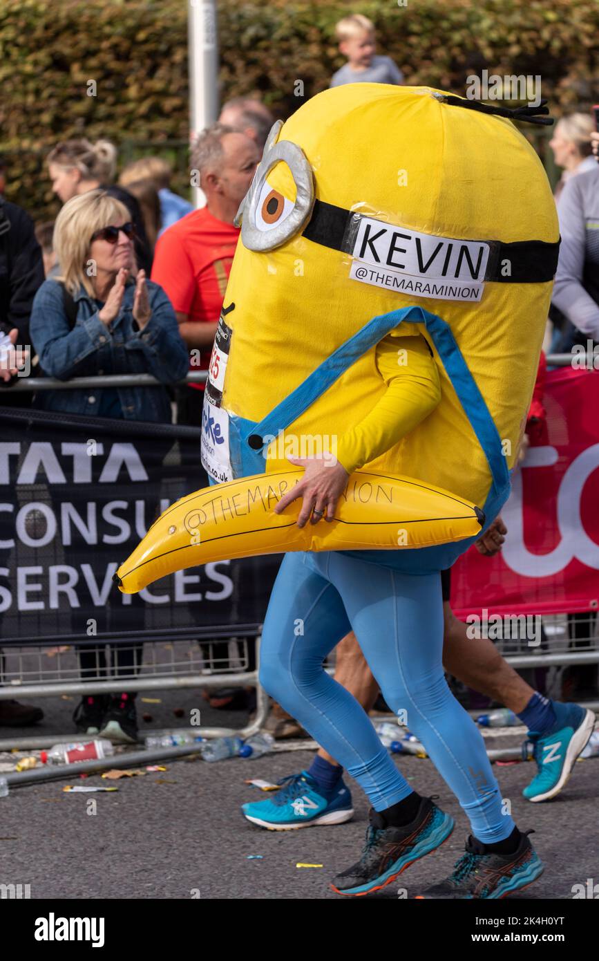 Kevin Isbister running in the TCS London Marathon 2022, on Tower Hill road, City of London, UK. Wearing a Minion costume for Stroke Association Stock Photo