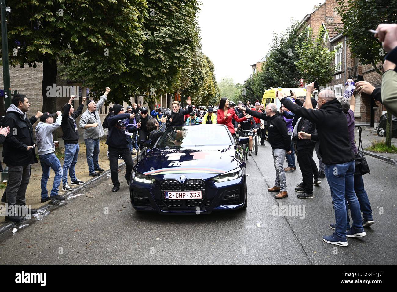 Remco Evenepoel and his partner Oumaima Oumi Rayane sit in a convertible car around supporters during a big bike ride to Brussels around world champion, Sunday 02 October 2022, part of the celebration of world champion Evenepoel, the 22 years old, from Schepdael, Dilbeek, became world champion after a great season with a win at the Vuelta, first Belgian in 44 years to win a big tour. BELGA PHOTO JASPER JACOBS Stock Photo