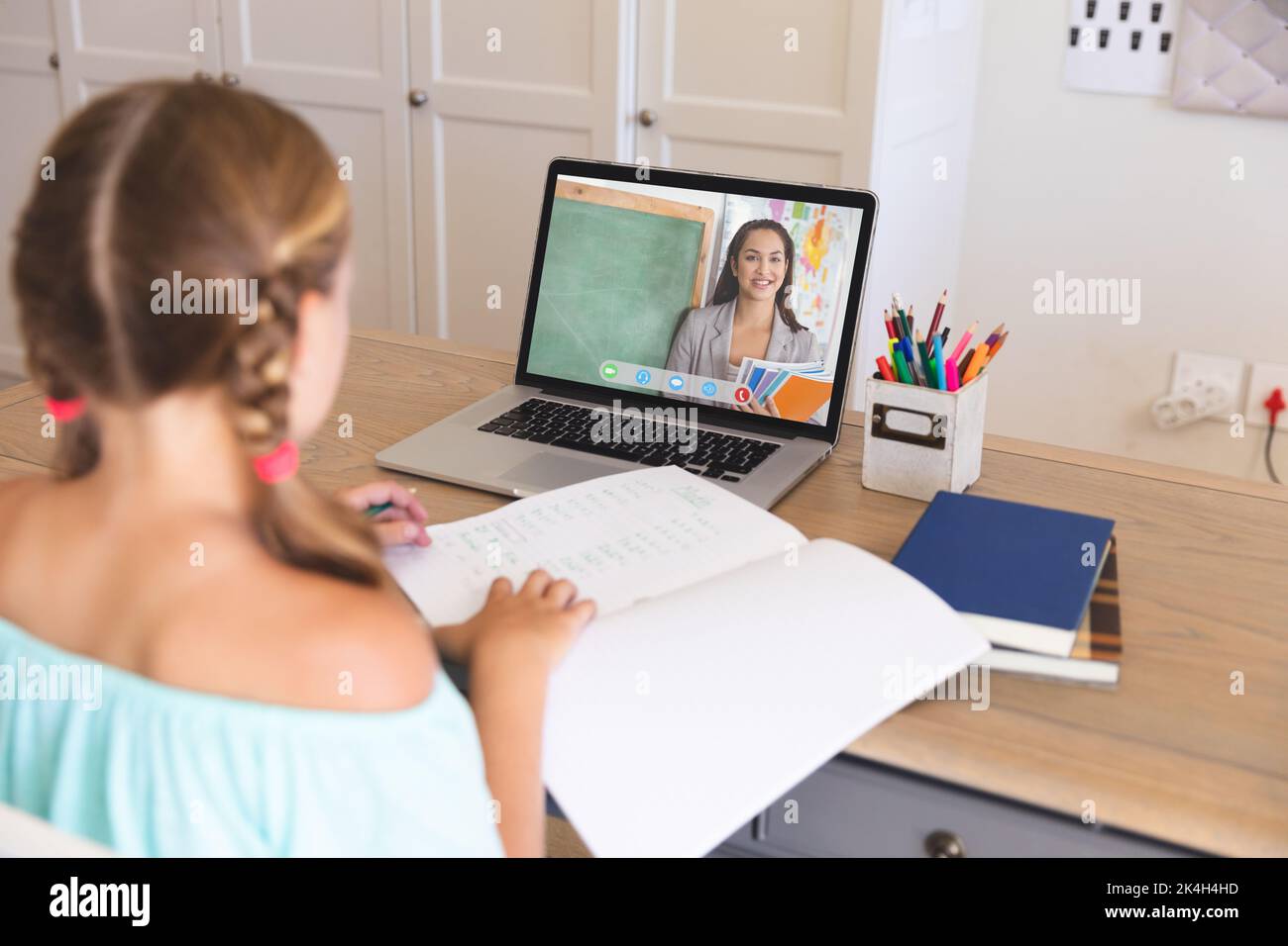Caucasian girl using laptop for video call, with smiling biracial ...